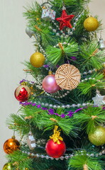 Christmas artificial tree decorated with toys