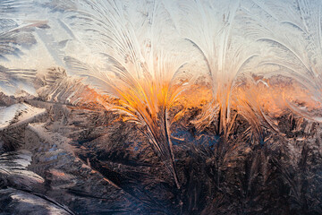 Sunset through frosty pattern on glass