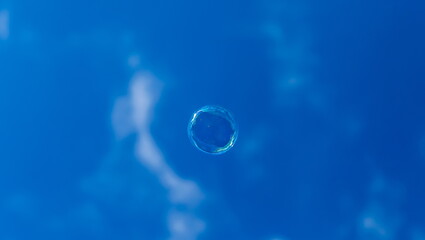 Soap bubble on blue sky background