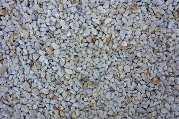 Textured background of marble rubble in various shades of gray.