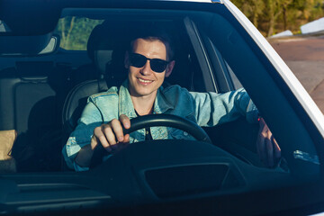 guy driving a white car