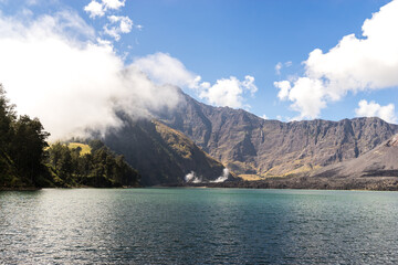 Big calm green lake in mountains, trekking and camping travel concept, beautiful landscape in Lombok Island, Indonesia, on the way to summit mount Rinjani 