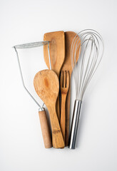 Set of kitchen utensils on a light background. Top view, vertical orientation. Concept of culinary backgrounds.