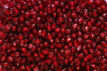 vibrant red pomgranate seeds close up shot