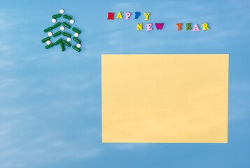 Christmas tree made of green capsules and white tablets and the inscription Happy new year. The sun's glare. The concept of a holiday during the period of the pandemic