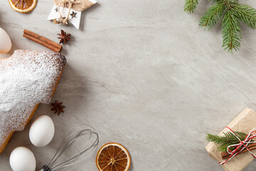 The concept Christmas card. Homemade baking, ingredients, Christmas tree-shaped biscuits, gifts, spruce branches and decorations. Top view, flat lay.