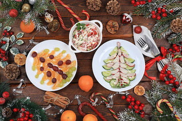 Christmas new year food, detox diet concept, traditional festive tangerine and vegetable salads, food design idea, place for recipe, flat lay,
