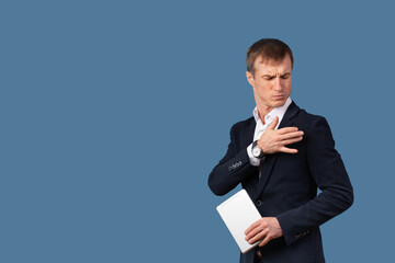 An arrogant male businessman in a suit shakes the dust off his clothes and shoulder with contempt....