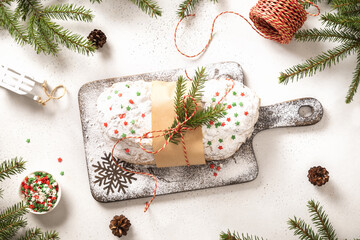 Christmas stollen with ingredients raisin and candied fruit on white. View from above.