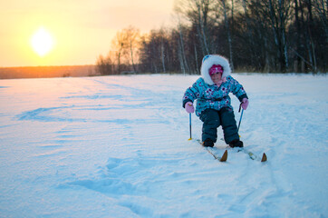 Fototapeta na wymiar A girl and her first winter skiing trip