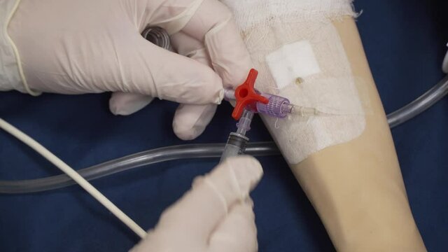 Close-up, a peripheral venous catheter is installed on simulation doll hand