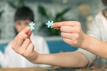 Home jigsaw puzzle. little boy and his mother playing