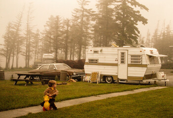 1970's retro camper and child with duck toy