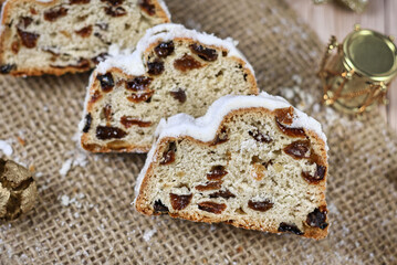 Slices of traditional German christmas season sweet food called 'Stollen' or 'Christstollen', a fruit bread with nuts, spices and dried or candied fruit, coated with powdered sugar