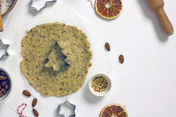 Gluten Free Christmas Cookies. Making homemade Christmas tree gluten-free cookies. Rolled dough and cutting molds, top view, flat lay, copy space