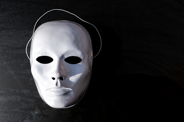 White theatrical mask on the black background