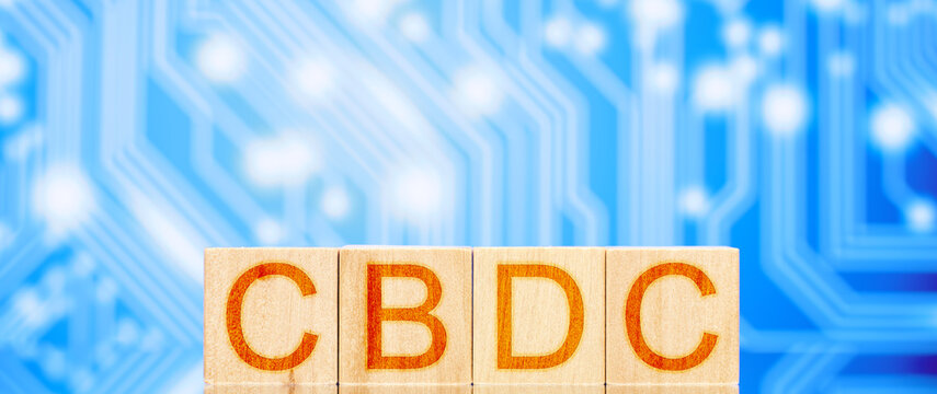 cbdc. wooden cubes with cbdc lettering on blue background