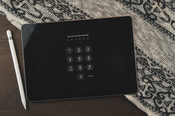 Digital Tablet and electronic pen on a wooden table. The template is empty. Workplace at home.