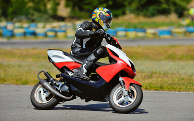 Motorcycle practice leaning into a fast corner on track