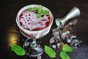 The cocktail is beautiful, delicious with lime, mint and ice in a glass