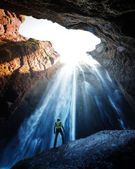 Man in the cave near the Gljufrabui waterfall, Iceland, Europe. Landscape photography