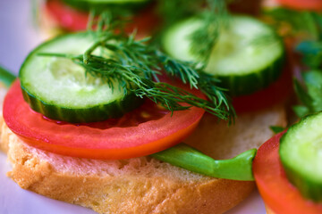 Diet sandwiches with greens, cucumber and tomato on a white plate