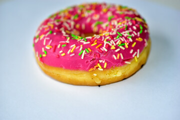 Yellow and red American delicious donut on a white background