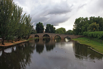 Fototapeta premium Old stone bridge over river, Spain
