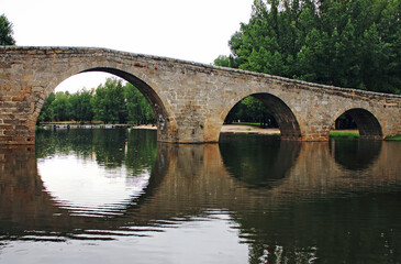 Fototapeta na wymiar Old stone bridge over river, Spain
