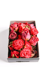 Dried rose flowers in cardboard box.