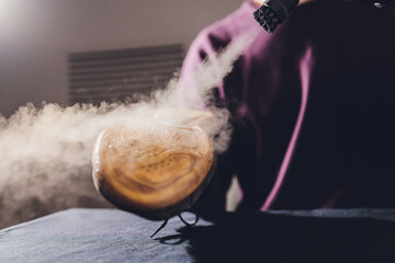 washing the dirty cleaning the shoes with a steam cleaner.