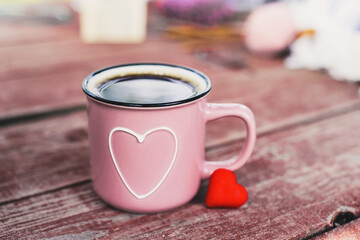 Pink mug with shape of hearts on wooden table. Big and small heart. Romantic, St Valentine's Day concept.
