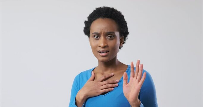 Shocked african american woman screaming in fear and sighing in relief over white background