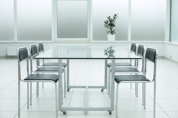 Black chairs glass table in office space