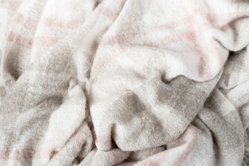 Crumpled gray wool blanket. Soft and warm fabric crumpled in folds. Texture