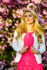 Spring collection. Spring woman in cherry flower bloom. girl pink blossom. fashion model in...