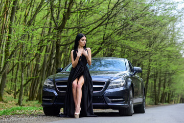 Hiking solo. Vehicle selective focus. Sexy woman go along road in fashion dress. Travelling and wanderlust. Pretty girl travel on foot. Travel by car. Auto and woman traveler. Trip and wanderlust