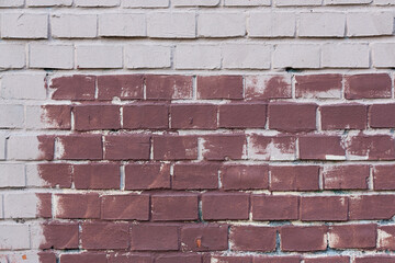 Old painted brick wall. Texture of rough brickwork. Masonry background.