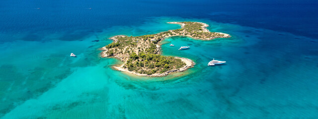 Aerial drone ultra wide photo of tropical exotic Caribbean island bay visited by luxury yachts and sailboats