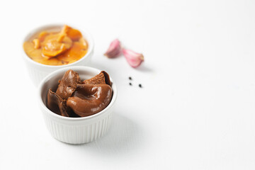 Ceramic bowls with canned mushrooms. Fermented food on a white background