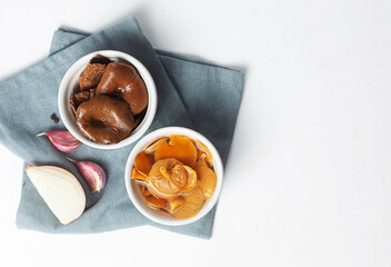 Ceramic bowls with canned mushrooms. Fermented food on a white background