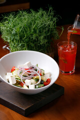 delicious Greek salad in a bowl on the table in a restaurant.