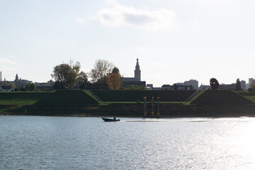 Fototapeta premium boat driving in front of the Skyline of the Dutch City of Nijmegen