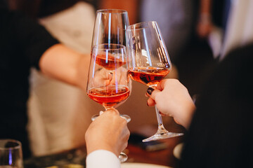 wine glasses in hands of people at party.