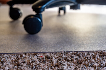 Transition between carpet and hard protective mat for a home office rolling desk chair