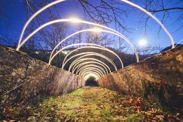 Light painting on a bridge on the moonlight