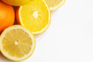 Fresh cut lemon and orange citrus fruits on white background