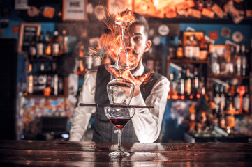 Charismatic tapster mixes a cocktail on the bar