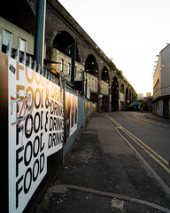 City street with Food and Drink sign on fence, Birmingham