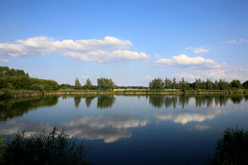 Fototapeta na wymiar Beautiful lake on a sunny day with clouds